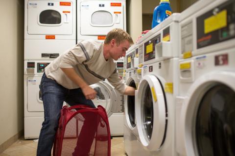 student doing laundry